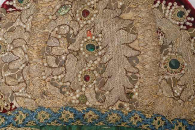 Detail of the decoration with applique elements (pearls, spangles, multicoloured stones)