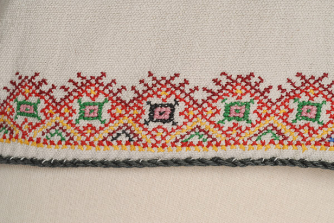 Hem, detail of embroidered decoration, detail 