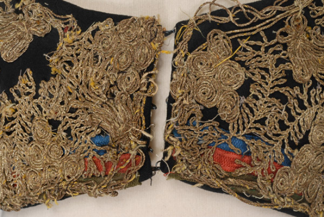 Detail of the decoration at the tongue, applique silk ribbons and gold embroidery