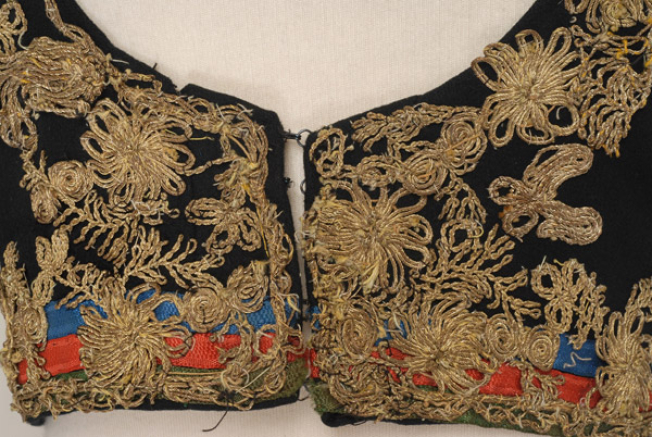 Detail of the decoration at the tongue, applique silk ribbons and gold embroidery