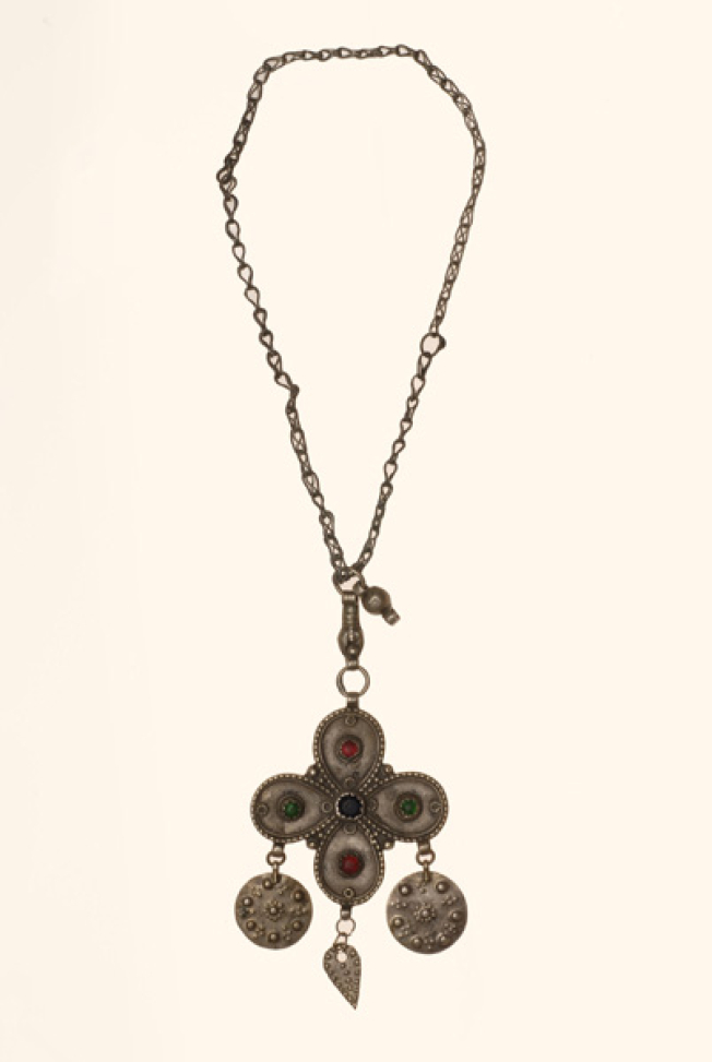 Silver cross decorated with variegated glass stones and suspended grainy elements
