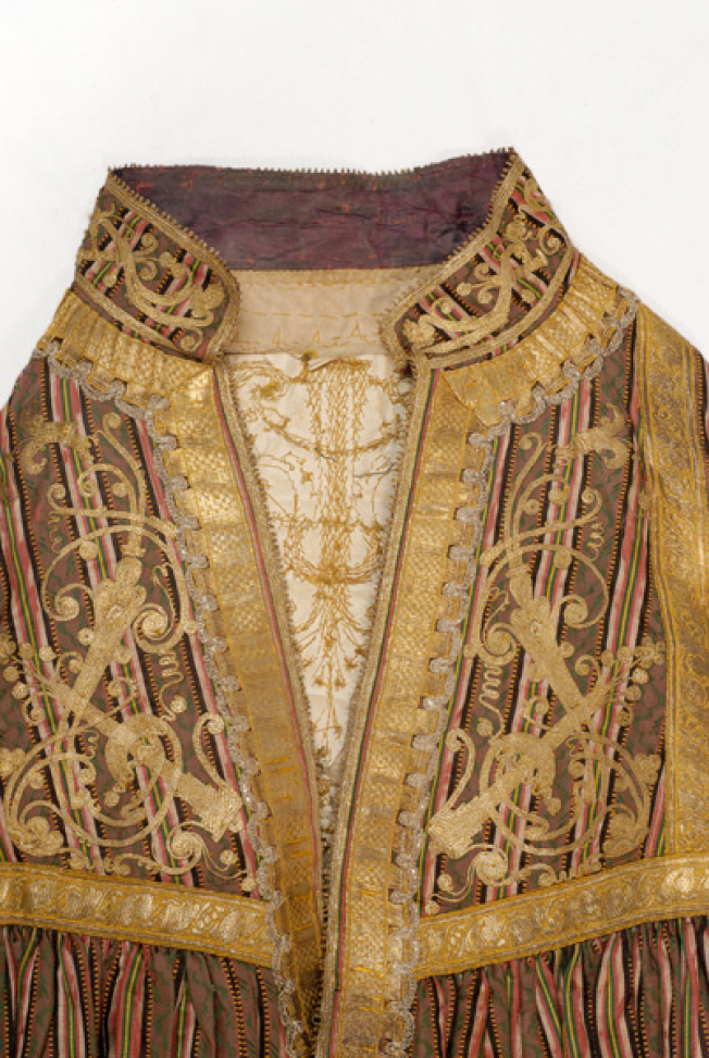 Detail of the applique decoration at the chest, fillet and gold embroidery 