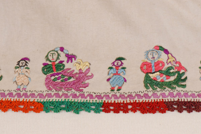 Detail of the embroidery: mermaids and cadi