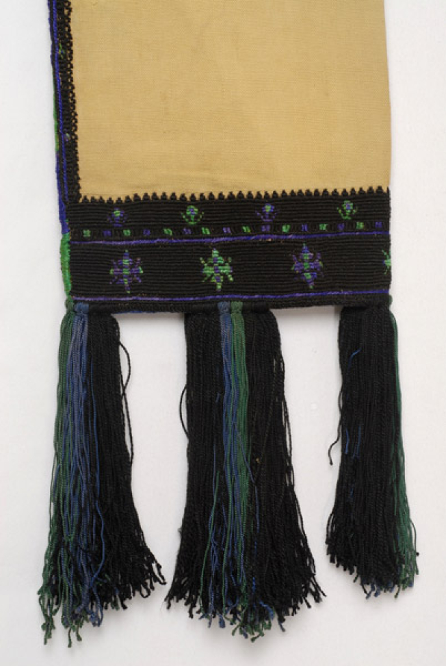 Linen sleeves, Detail of the decoration with coloured stylized motifs and silk over tassels