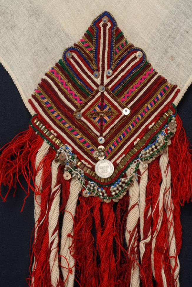 Detail of the embroidery, embroidery and applique elements at one of the corners of the kerchief