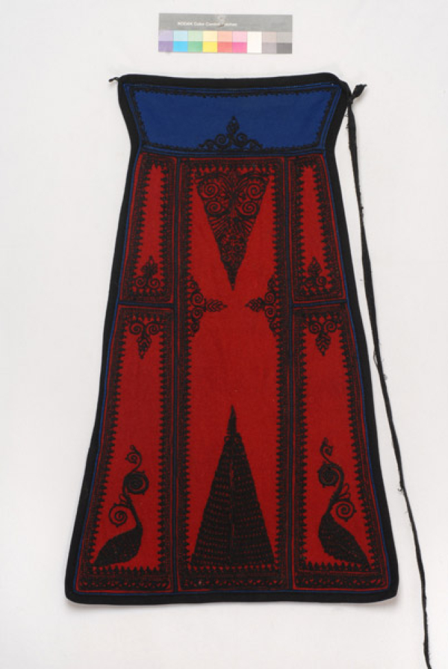 Karagounian skoutisia apron in red colour embroidered with black outrades (silk braids)