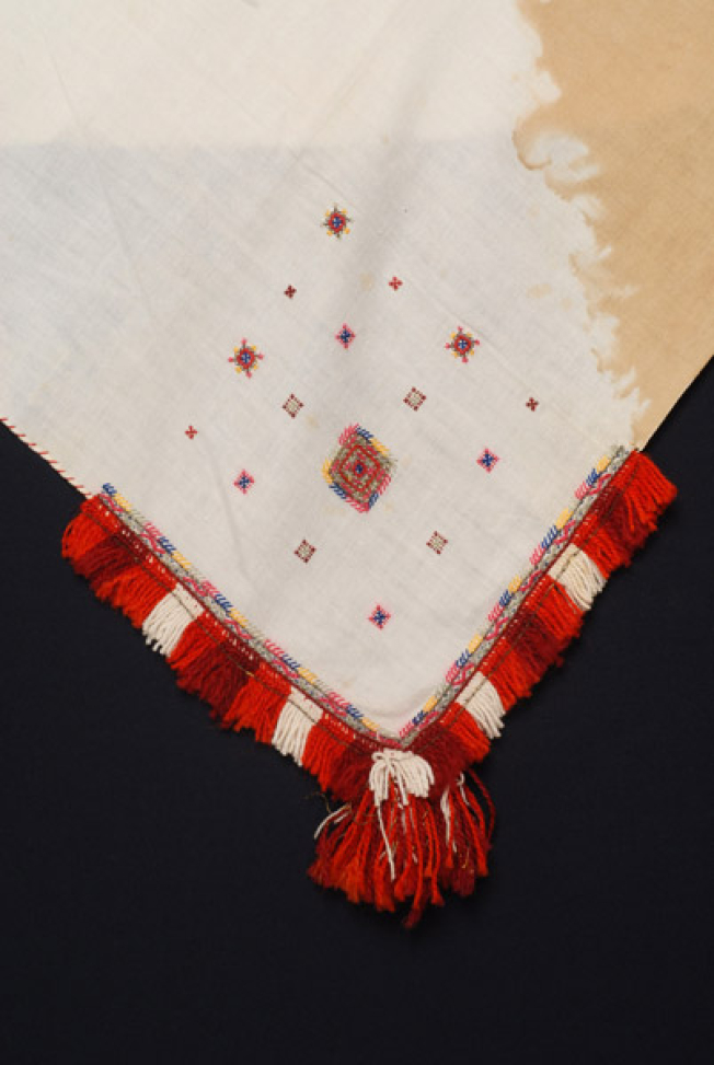 Detail of the decoration, embroidery and applique elements at one of the corners of the kerchief