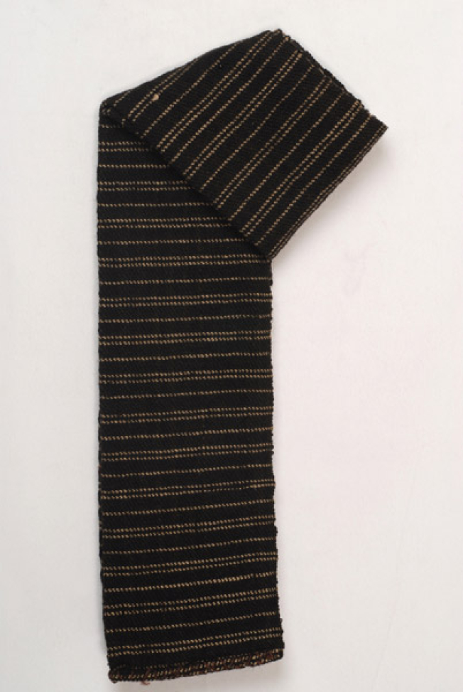 Handwoven black woollen sash with embellished narrow stripes in a horizontal arrangement, folded lengthwise