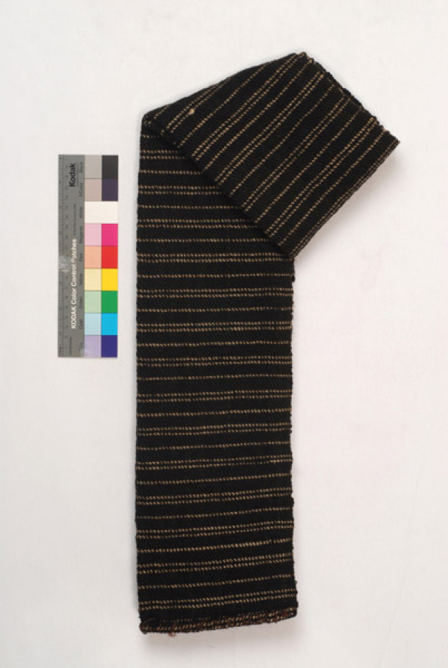Handwoven black woollen sash with embellished narrow stripes in a horizontal arrangement, folded lengthwise