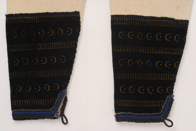 Edge of the sleeve, detail of the applique decoration with beads and black and bright blue woollen cordon