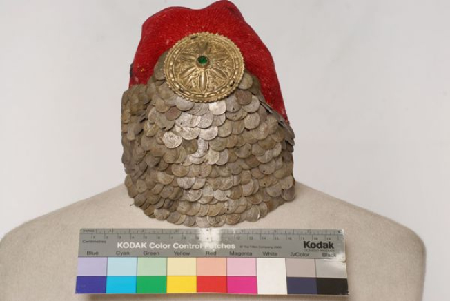 Paradomeno tarbush. Applique decoration with silver coins and a metal tassle with a green stone in the centre