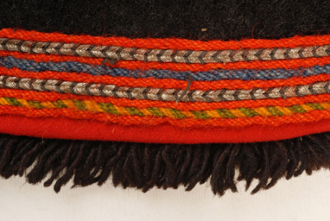 Border edge, detail of the applique decoration with colourful, woollen strimmata and silver cordons