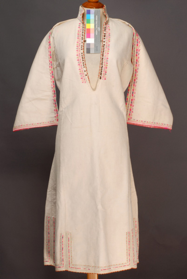 White cotton woven chemise with upright small collar, ornamented with spangles, coloured beads and multicoloured embroideries