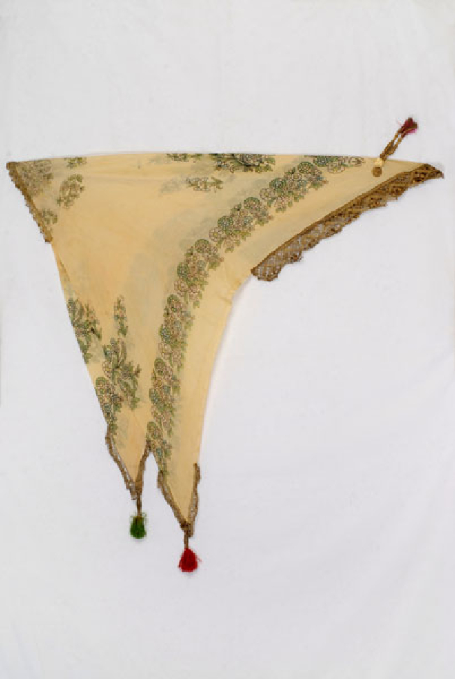 Yellow printed kerchief with leafy scrolls and flowers. Applique decoration with gold lace, guilded coins and tassels