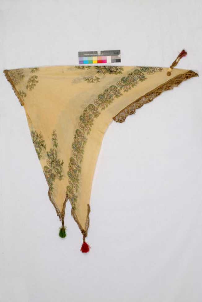 Yellow printed kerchief with leafy scrolls and flowers. Applique decoration with gold lace, guilded coins and tassels