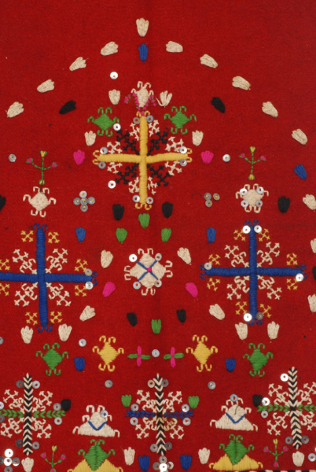 Detail of the decoration, embroidered cross framed by smaller embroidered motifs and spangles