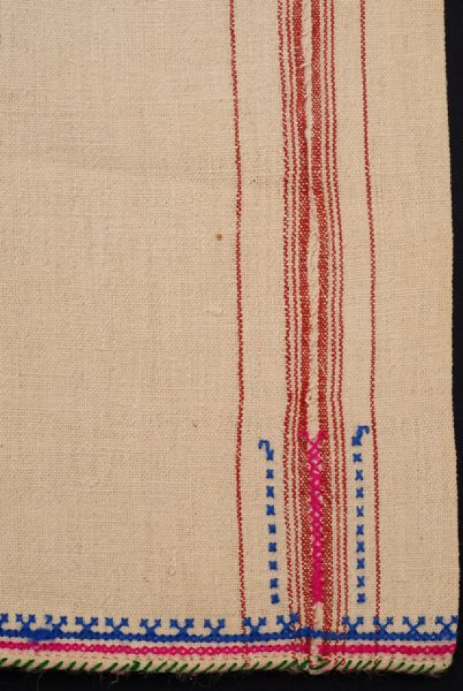 Detail of the decoration at the sleeve, embellished stripes, embroidered joint and embroidery at the border