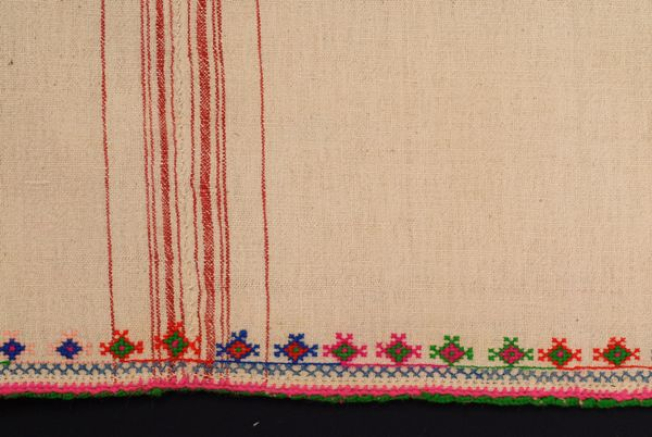 Detail of the decoration at the border, fine bibila (crocheted lace) and embroidery