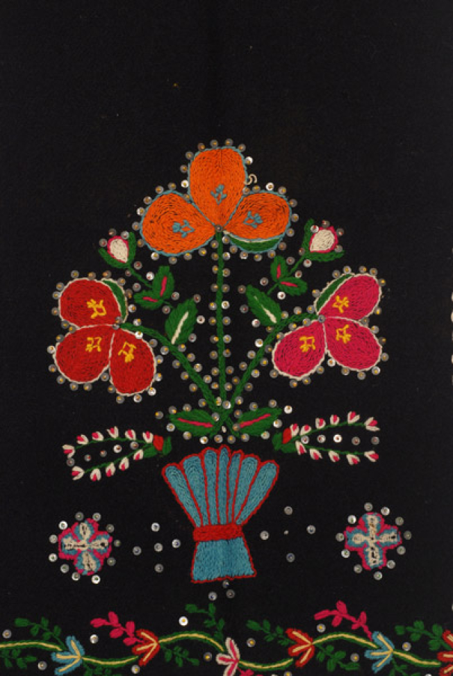 Detail of the embroidered decoration, pot with flower and small crosses, trimmed with spangles throughout