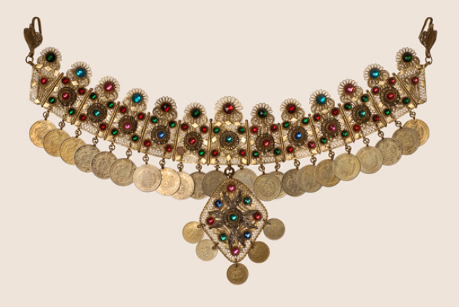 Wiry gilt yordani decorated with variegated glass stones and coins