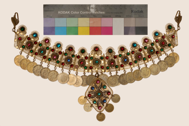 Wiry gilt yordani decorated with variegated glass stones and coins