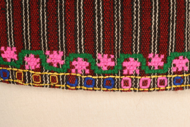 Detail from the hem of the foustani (dress) at the back, where the fastening stitch ountitsa and the counted embroidery are traced