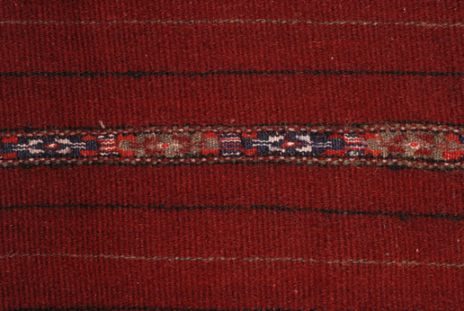Detail of the handwoven decoration, mitouni: loom embroidered horizontal band just above the border