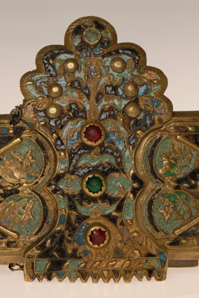 Detail of the decoration with colourful enamel, colourful stones, flowers, the tree of life and a small cross at the top of the buckle. The inscription reads 1885, the year of the engagement
