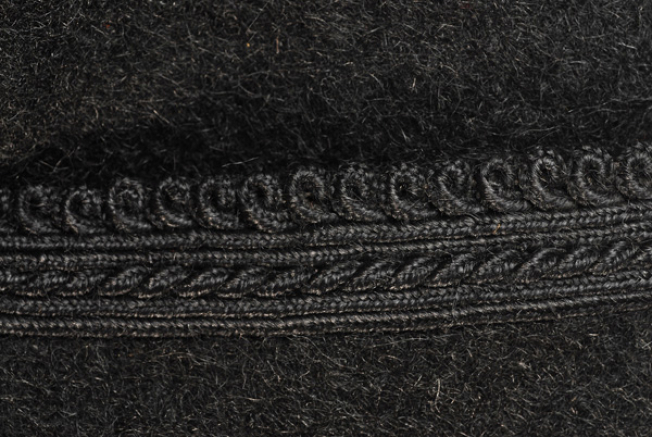 Sleeve, detail of the applique decoration with plain coloured cordons and loops