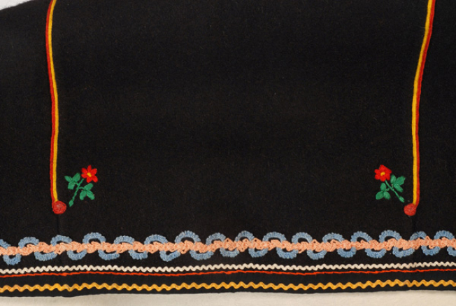 Detail of the border decoration. At the lower part, applique braids with embroidered flowers above