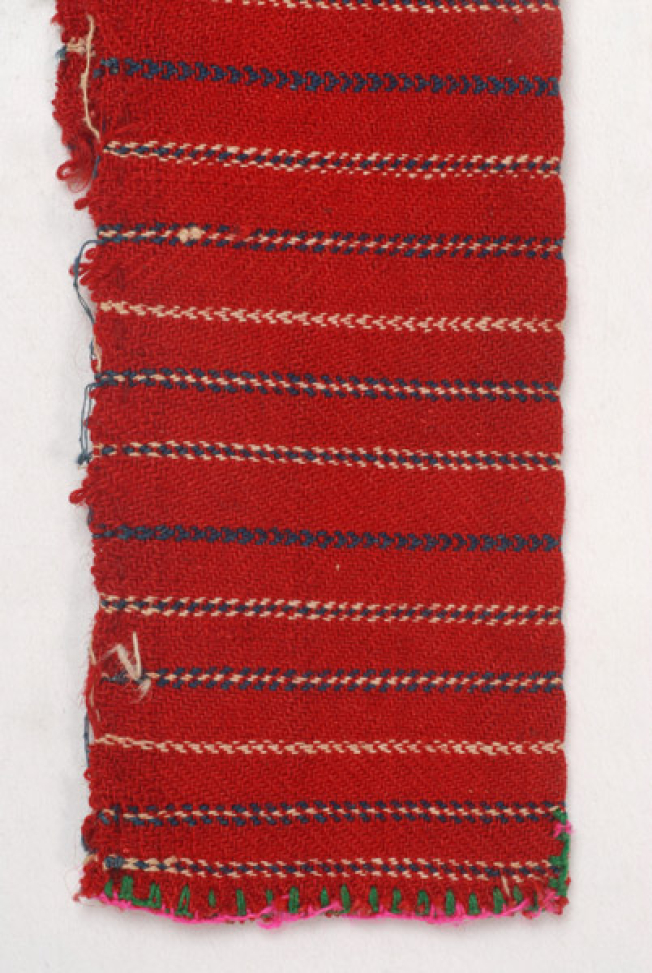Detail of the embellished decoration. At the vertical side, the fastening stitch ountitsa with green and fuchsia thread.