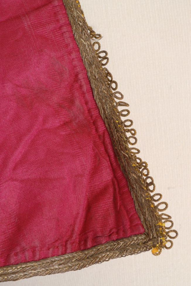Front, detail of decoration (gold strap)