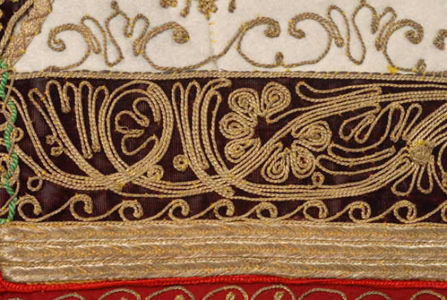 Embroidered edging made of crimson rich brocaded fabric