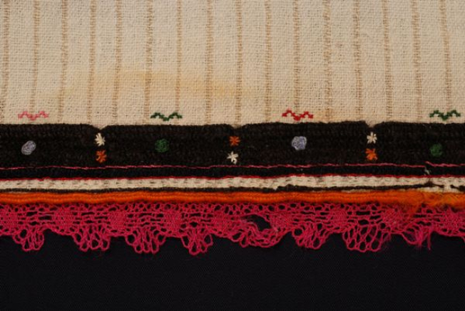 Detail of the decoration at the border, embroidered band, applique cordon and balabardenia freza (fuchsia lace)