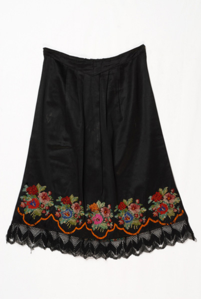 Black satin apron embroidered with multicoloured flower motif