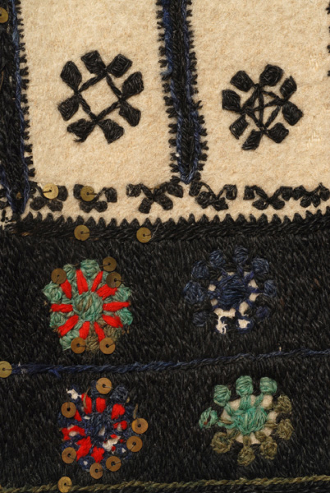 Red flowers at the base border. Higher up, stylized flowers, one of them with a cross