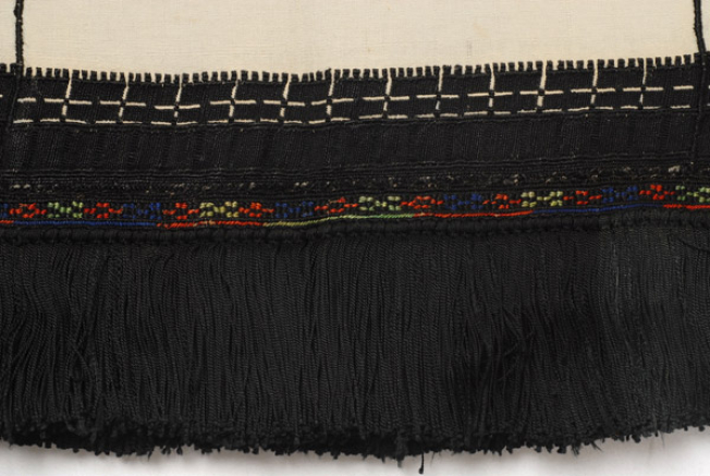 Border, detail of the decoration with thick black embroidery and with yiagli or plechtra (coloured band with stylized motifs)