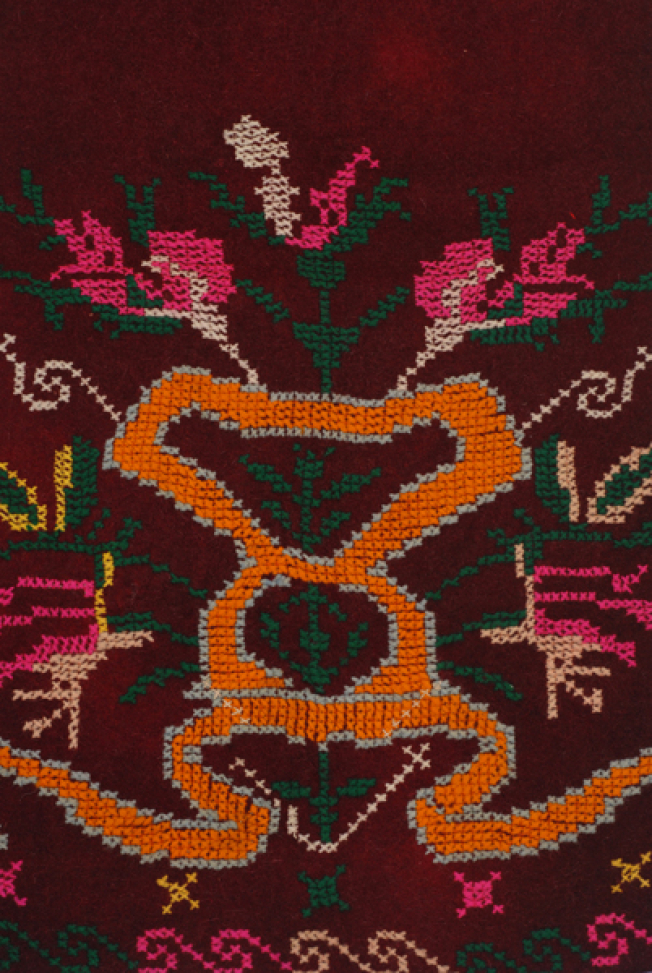 Detail of the embroidered decoration, big flowers growing in a stylized pot