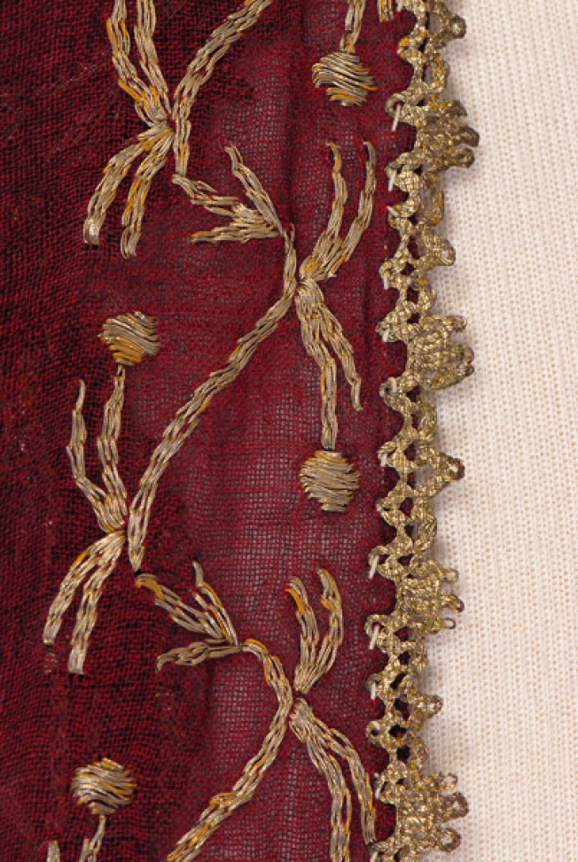 Sleeve, detail of the decorative motif and the lace 