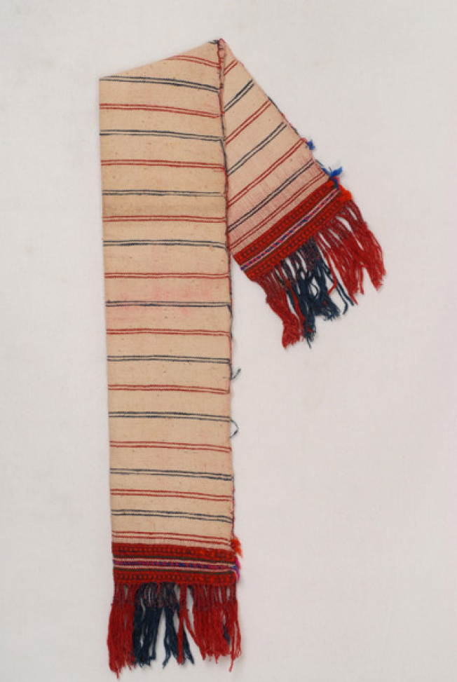 Karpa, white cotton woven towel, with embellished multicoloured patterns at the two edges and fringed edge