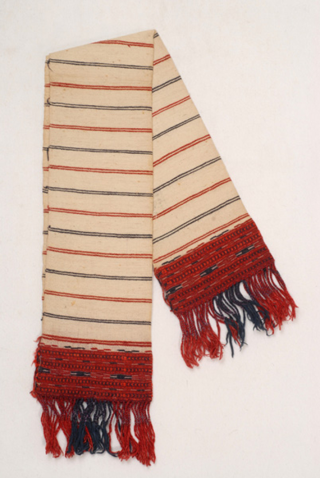 Karpa, white woven towel, with embellished coloured patterns at both sides and fringed edge 