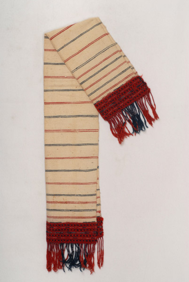 Karpa, white cotton woven towel, with embellished multicoloured patterns at the two edges and fringed edge