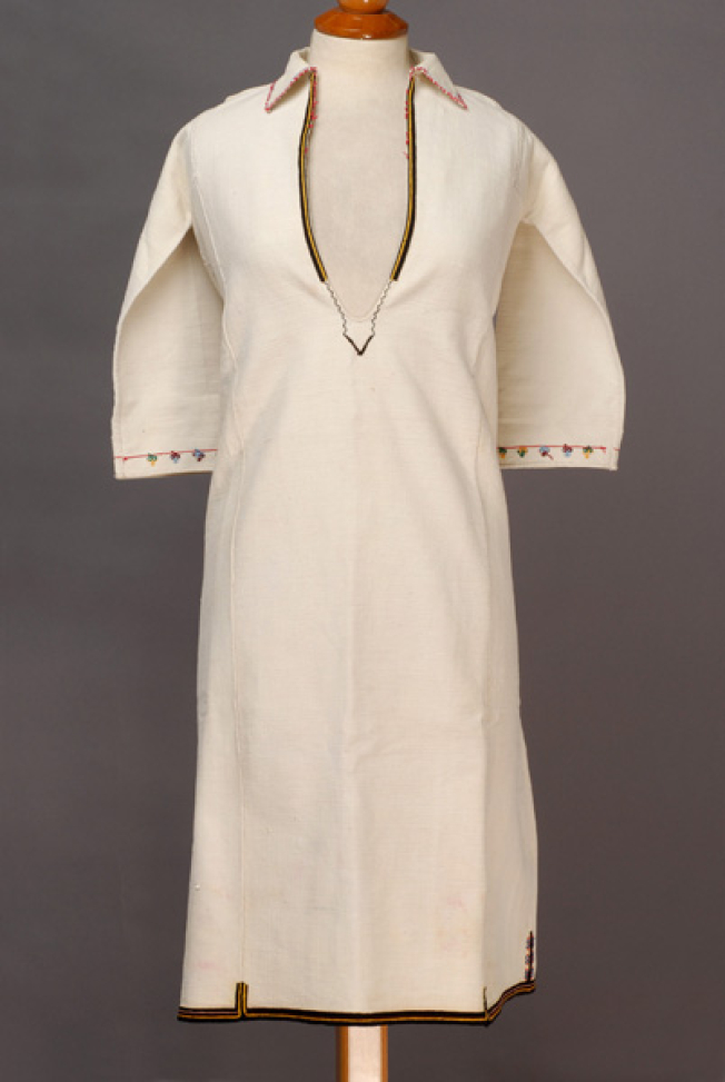 White cotton woven chemise, embroidered with woollen coloured threads