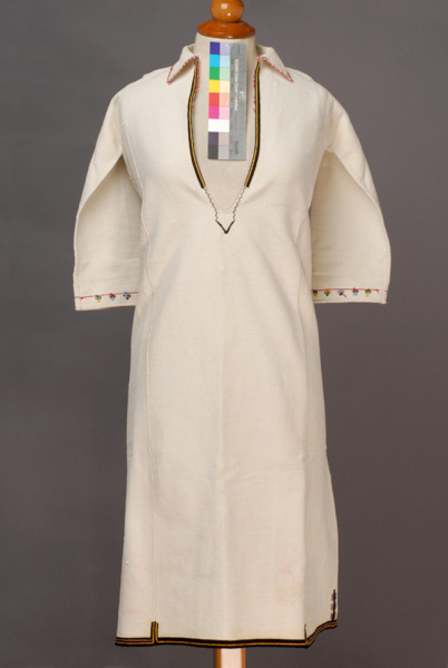 White cotton woven chemise, embroidered with woollen coloured threads