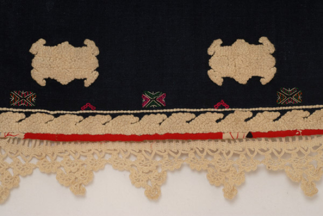 Detail of the decoration at the border, back: lace crafted with embroidery needle, bouchasi, grouses with water and vergako (first band), gatz'loudia and geometrical motifs(middle band) and tsarpaliares