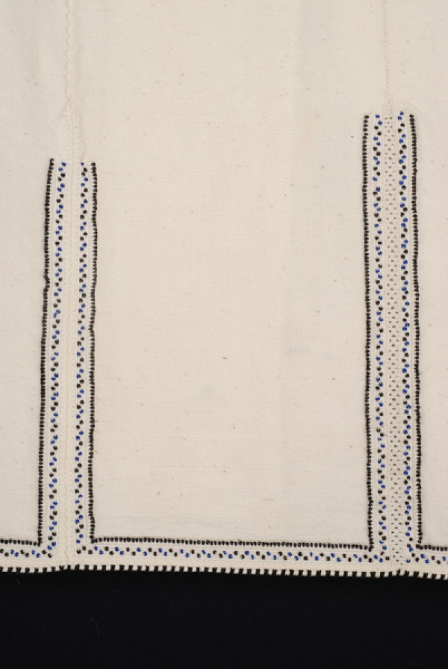 Border, detail of the embroidered joint of the seam and the applique decoration with colourful beads
