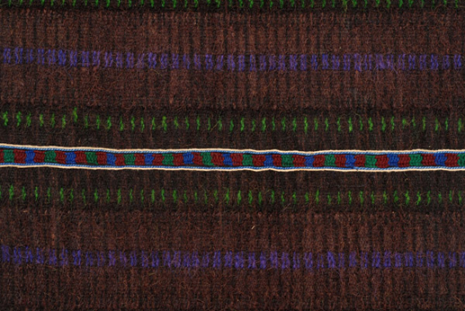 Horizontal joint, detail of the decoration with narrow embroidered band 