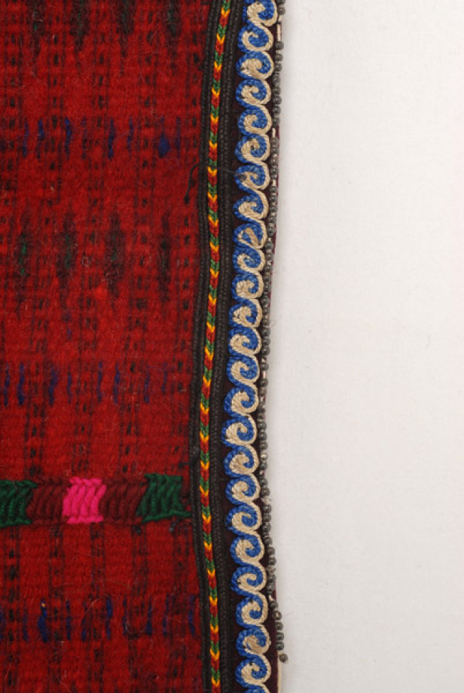 Edges of the apron, detail of the applique decoration with braids, beads and felt bands with double spiral meander