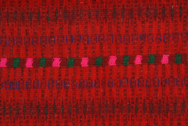 Horizontal joint, detail of the decoration with narrow embroidered band 
