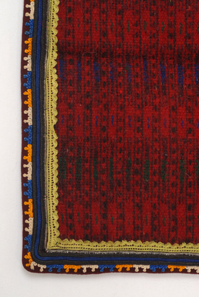 Edges of the apron, detail of the applique decoration with small lace sold by the metre, beads, cordons and felt bands with stylized motifs